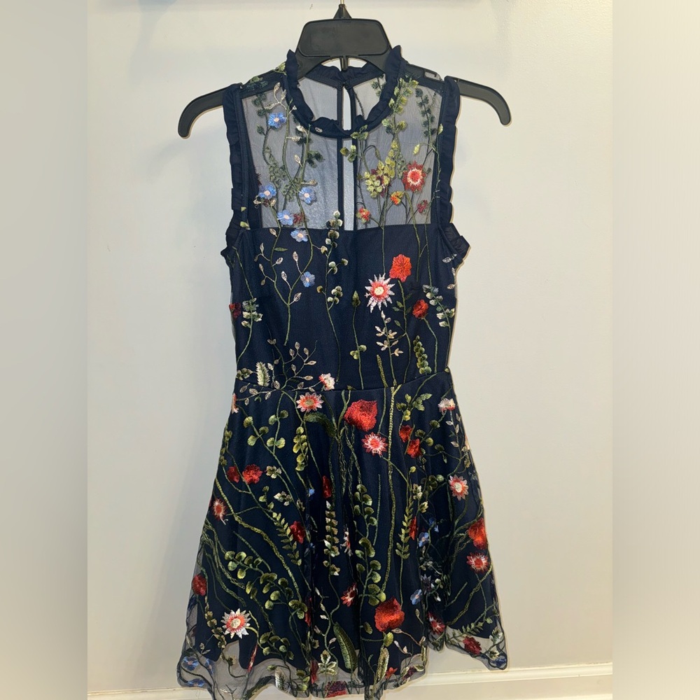 Navy homecoming dress with embroidered flower details on the whole dress.